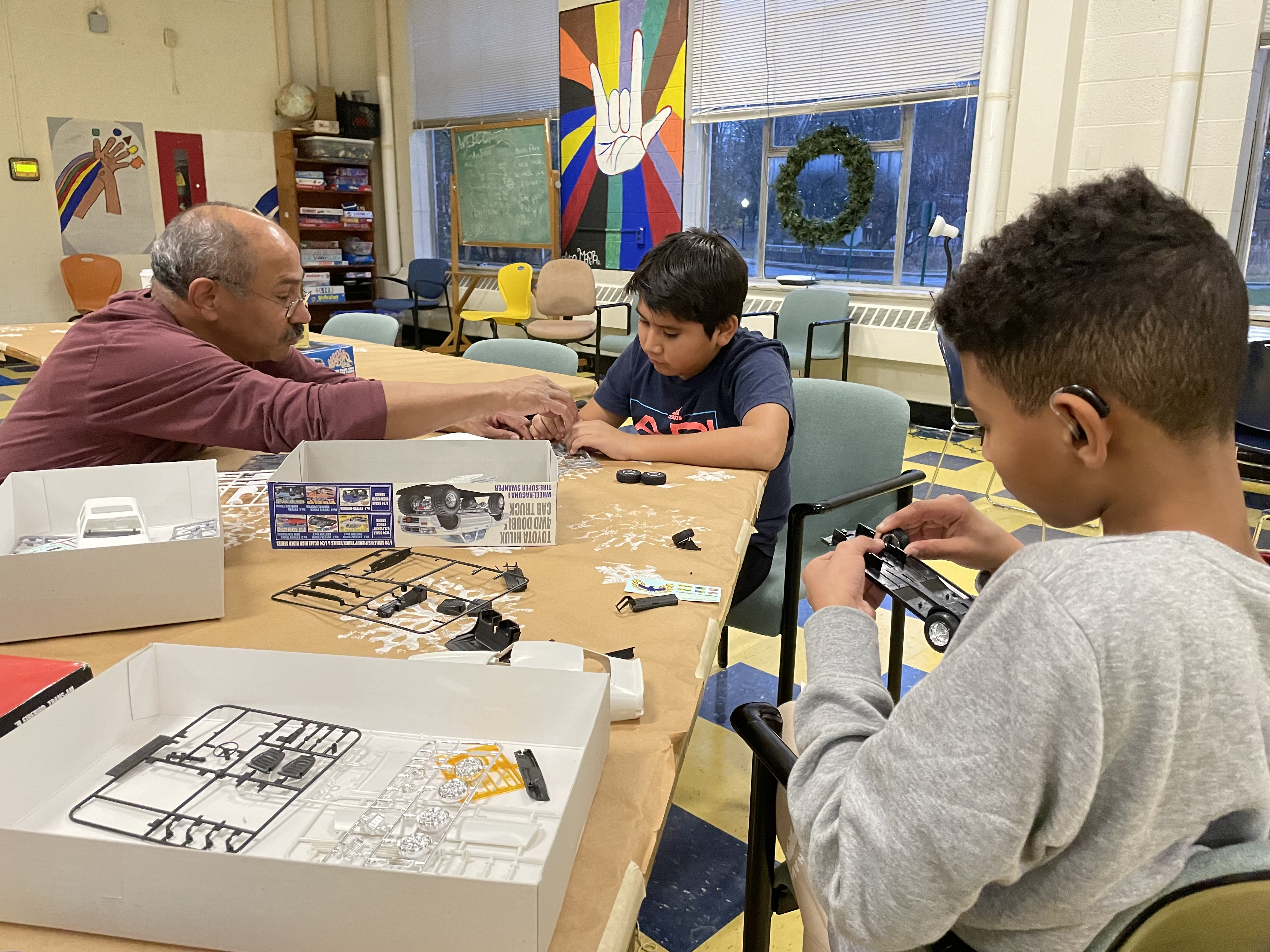 2 students and 1 staff building a model car